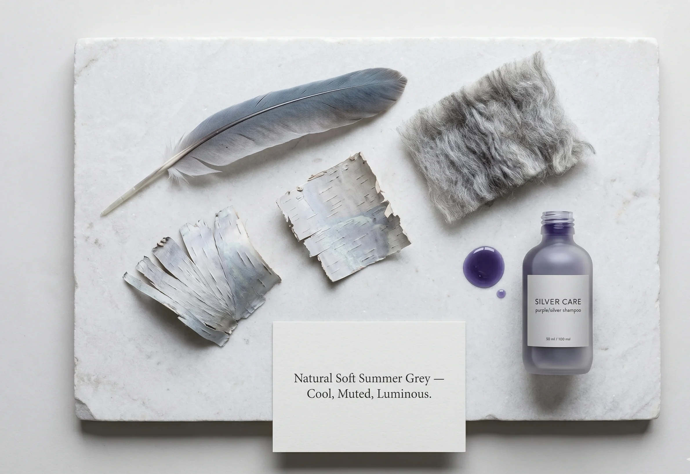 Heron feather, silver birch bark, and grey wool fleece illustrating the cool, muted quality of natural Soft Summer grey hair — alongside a purple toning shampoo for maintenance — showing why grey suits soft summer colouring