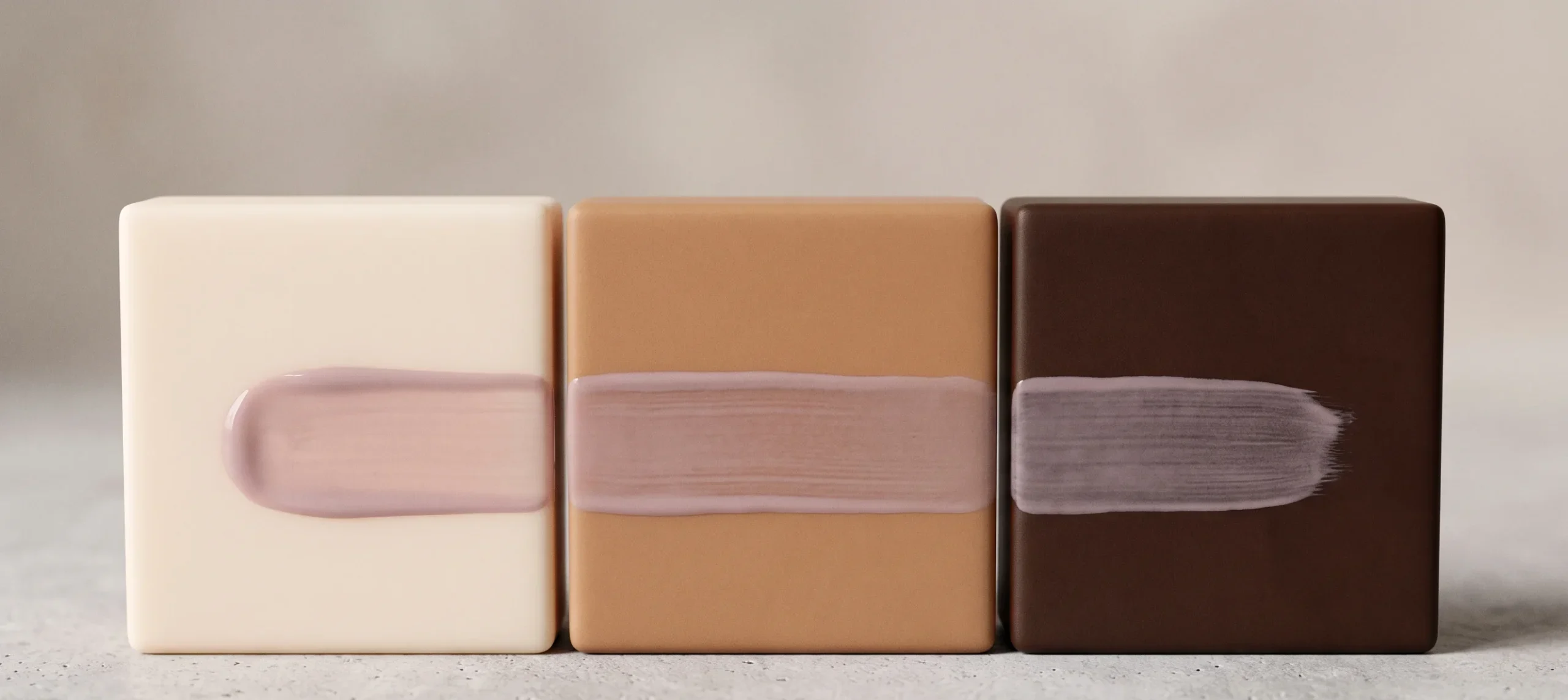 A swatch of sheer milky mauve polish painted across fair, medium, and deep brown resin blocks to demonstrate flattering milky nail tones for all skin depths.