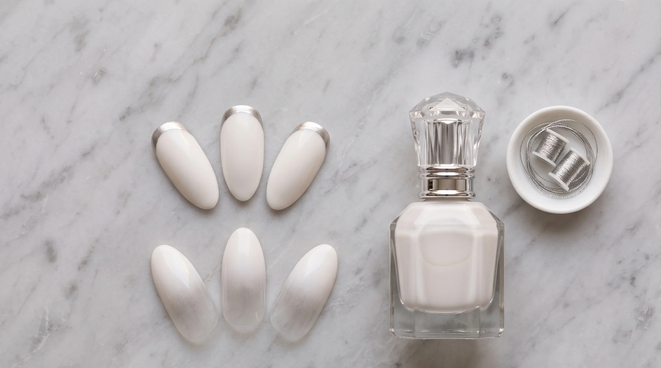 Elegant reverse French and milky ombré nail designs in milky white with silver shimmer, an elevated soft summer vacation nail look